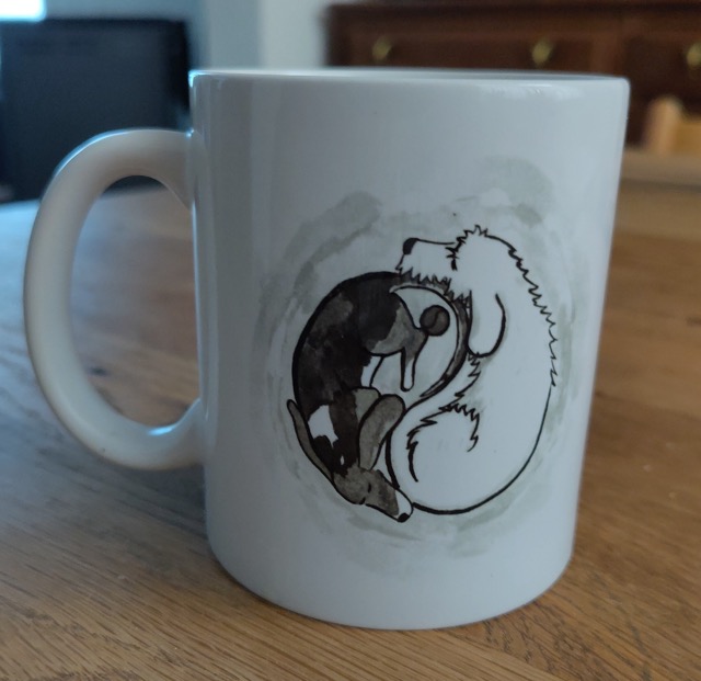 mug with print of two dogs lying together like a yin yang