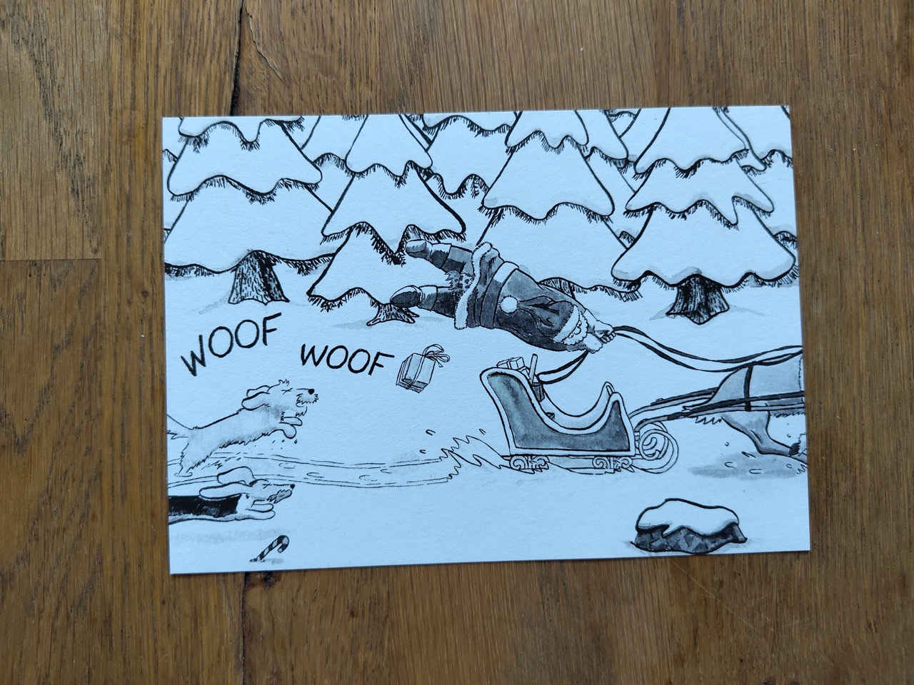 postcard with Santa Clause being chased by two dogs